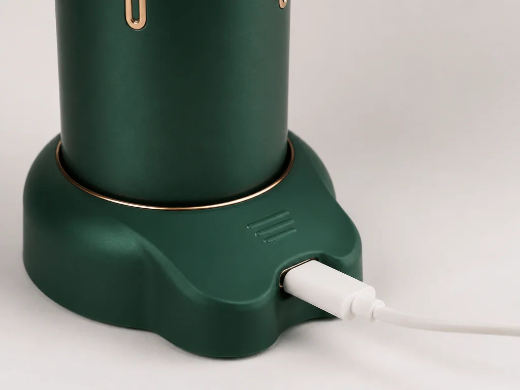 4:3 close‑up of the AirZen fan’s base, focusing on the USB‑C charging port. A slim white USB‑C cable
